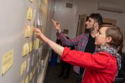 Students brainstorming together with a whiteboard and sticky notes