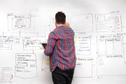 A student making plans on a white board.