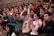 Image of new undergraduate students clapping at orientation inside the Cutler Majestic Theater.