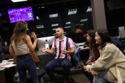 Group of students talking to each other behind a set