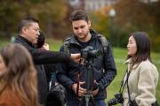 Photography students listening to a professor