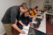 A faculty member helping a student during class