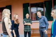 A group of people smiling, assembled outdoors