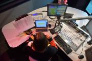 Student working in WERS radio studio