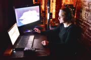 Student working with two computer screens
