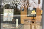 The Memories as Medicine Wooden Book in the front window of the ELC