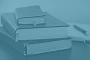 A photo of stack of books with a light blue overlay