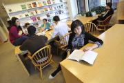 Students sitting around table working and talking to each other