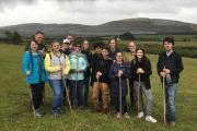 a group poses mid-hike in the fields