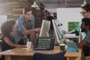People collaborating while pointing at computer screens