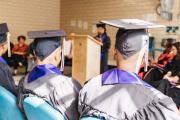 Students sitting in row with graduation cap and gown