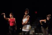 Students performing a dance on a stage