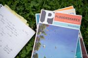 Stack of Ploughshares journals and a notebook in the grass