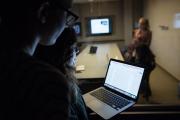 students look into focus room through two-way mirror