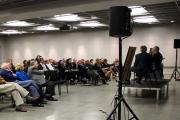 Two men presenting on stage to an audience of adults