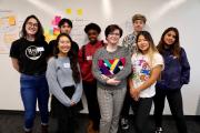 Image of students standing in front of white board