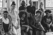 Black and white posed photo of students sitting on a couch
