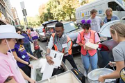 Orientation staff helping arriving students with the move-in process