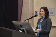 Liberal arts professor standing at a podium at an event in the Bordy Theatre 