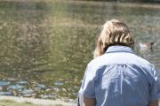 Image of a student sitting near a body of water