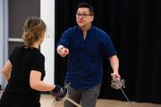 Teacher and a student with fencing blades
