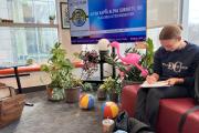 Student studying on a chair in the Intercultural Student Affairs office