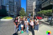 Students standing in a group on the sidewalk