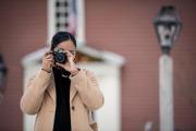 Student looking through the viewer of a camera from a distance