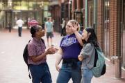 Three people standing in the Emerson alley