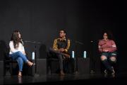 Three people speaking at a Teach In