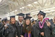 Four graduates posing for a picture