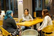 Group of students gathered around a table in the Lion's Den
