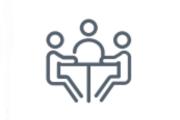 Three human stick figures sit at a table