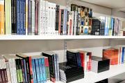 Two bookshelves full of books, featuring various titles on race, activism, and advocacy