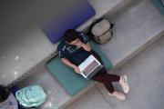 A birds' eye view of a student working on their laptop outdoors