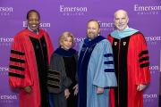 Four people in colorful graduate robes; President Bernhardt is the third person from the left