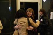Two people embracing and smiling outside of a building at Emerson College
