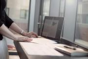 A student using a laptop in a bright office space