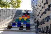 A view of an area on the Emerson Los Angeles campus, featuring a flight of stairs with soft chairs in varying colors covering the steps. 