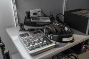 A close up image of headphones resting on top of a sound board