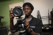 A student working with a Canon camera in studio space