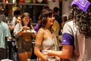 A student smiling during an interrcultural house party at Emerson College
