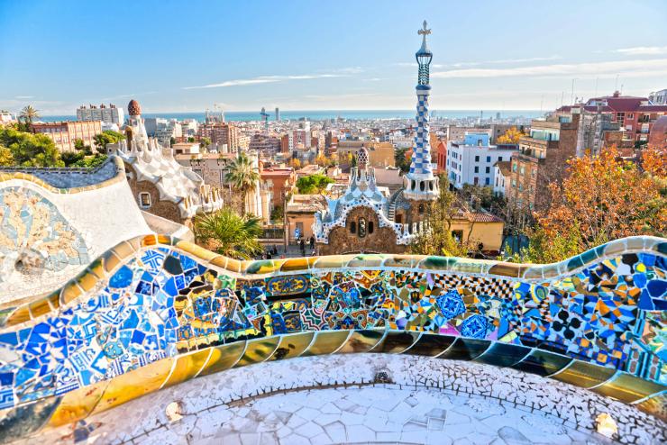 A landscape image of Barcelona outdoors, featuring a colorful mosaic tile wall