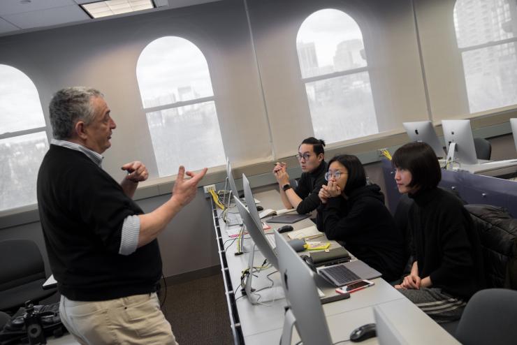 professor instructing students in a computer lab