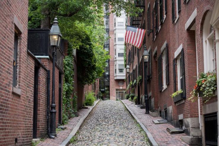 Cobblestone alley surrounded by brick buildings on either side
