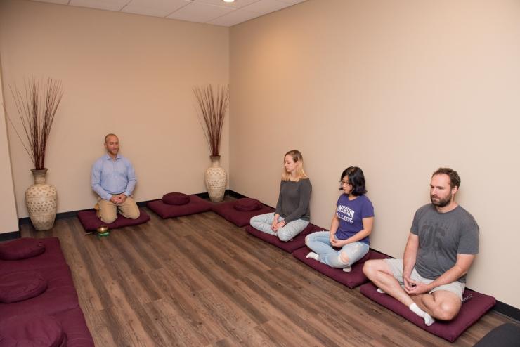 Group of faculty members and students in the meditation room