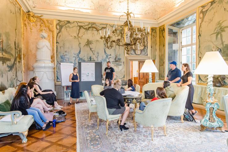 Students in discussion in a room in Salzburg