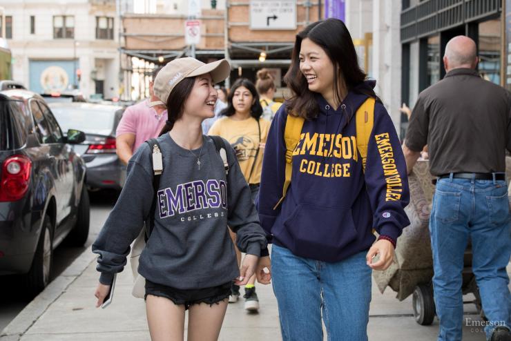 Students wearing Emerson sweatshirts and walking down the street