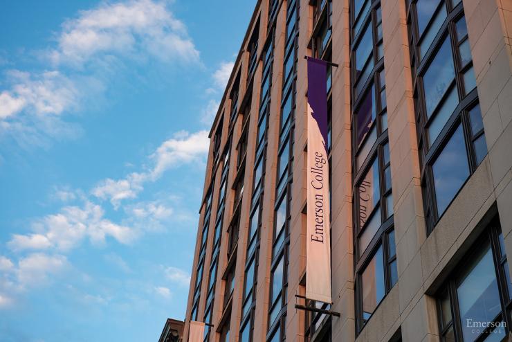 A photo of the side of a building with a focus on the Emerson College banner hanging off of the side