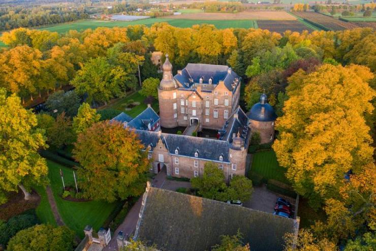 Overhead view of Kasteel Well castle in autumn surrounded by trees 
